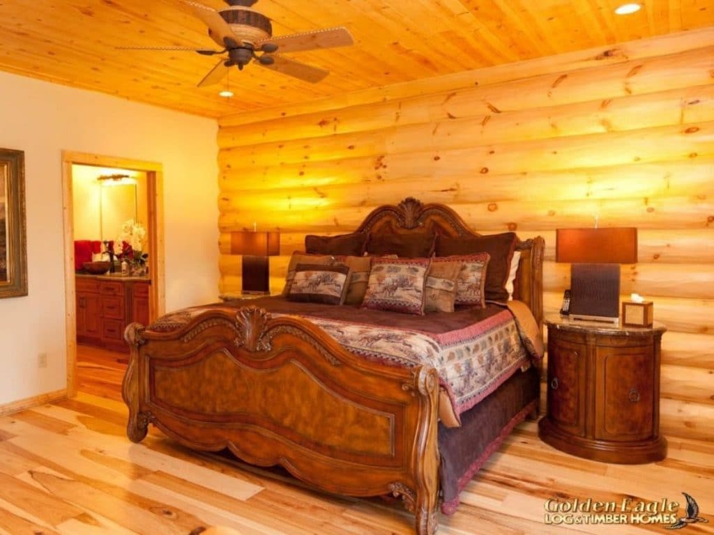 wood bed frame in log cabin bedroom