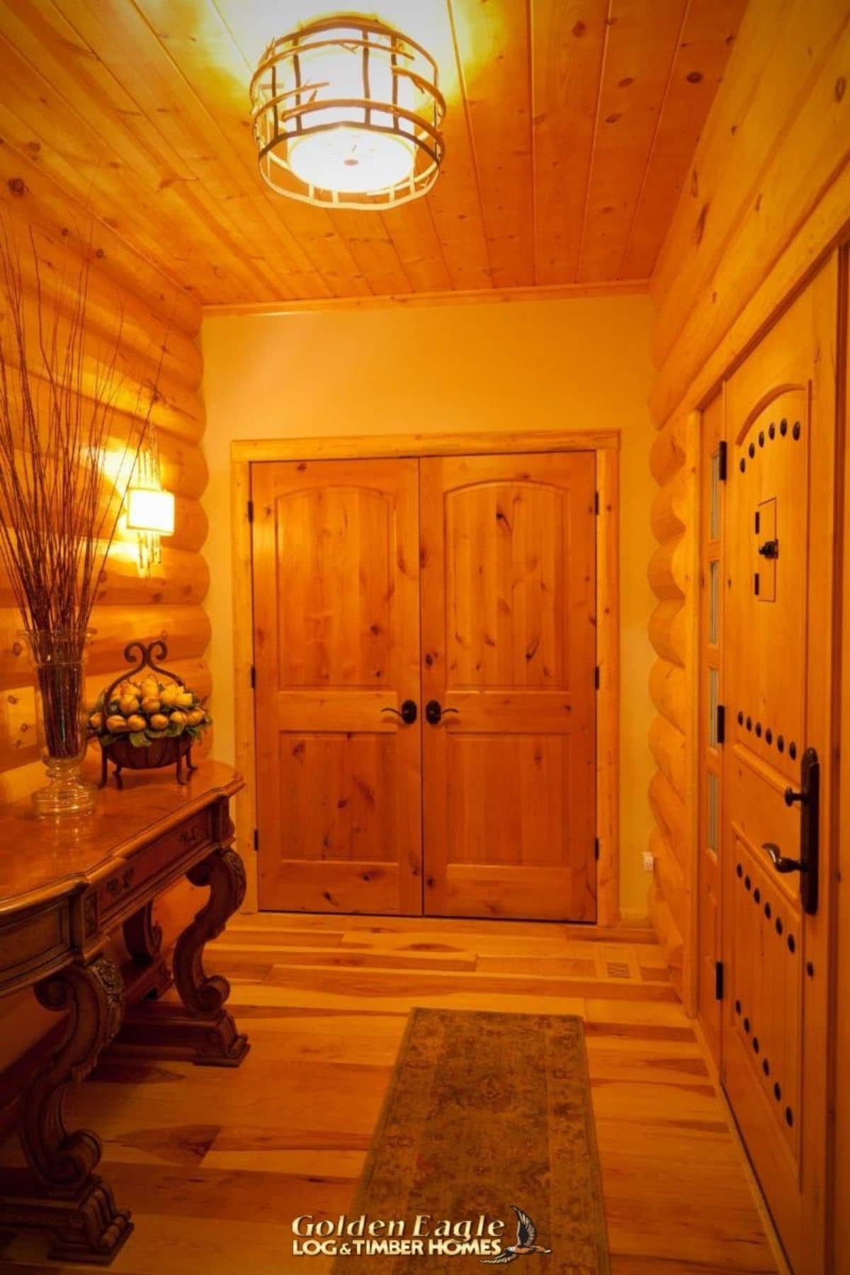 entryway in log cabin with table on left of image