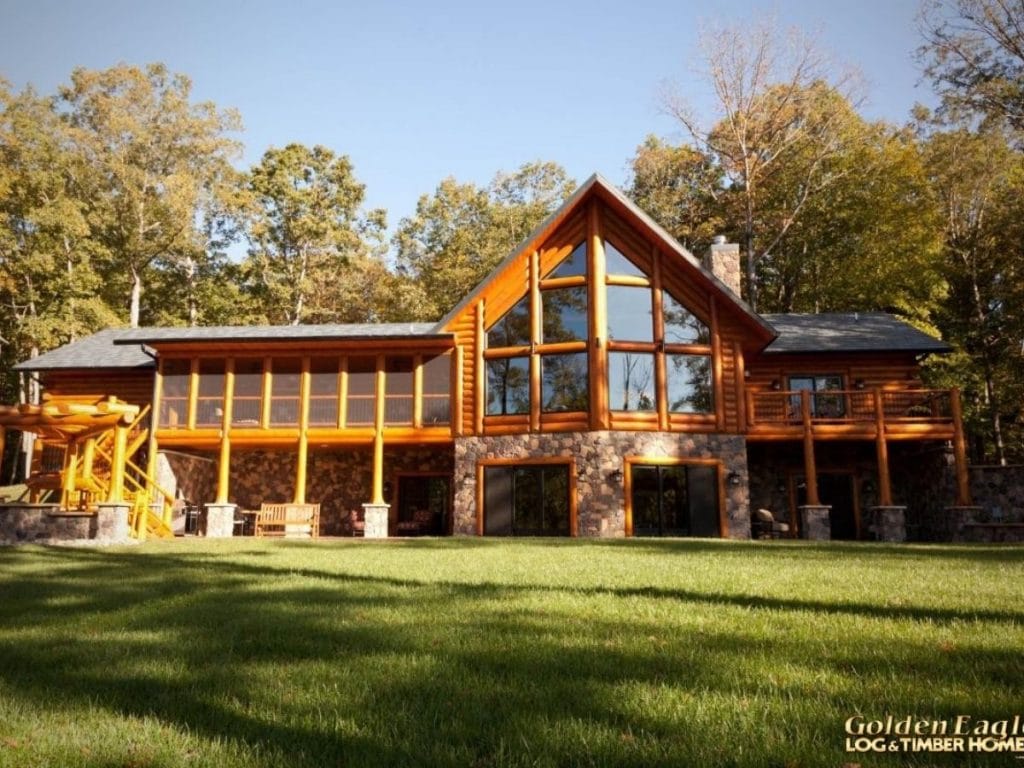 back of log cabin with picture windows on back wall