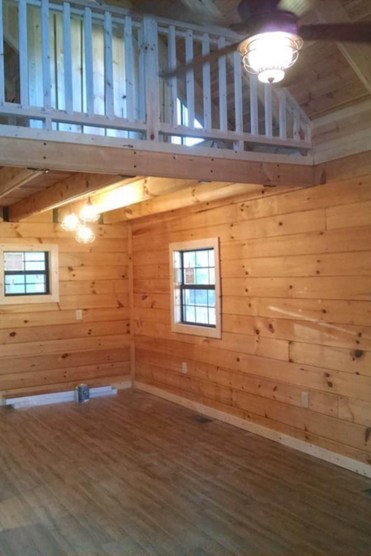 open living space in log cabin with loft above