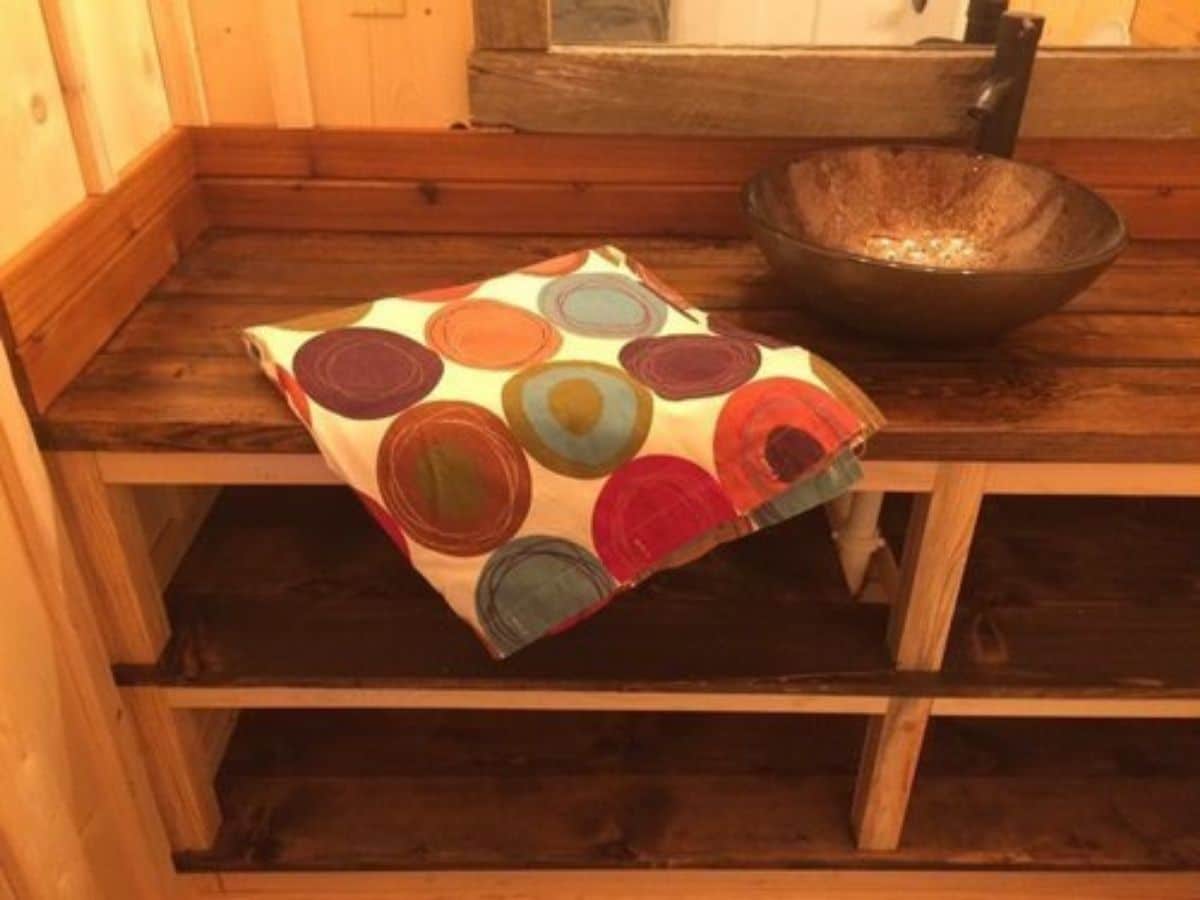 colorful towel on counter next to sink in bathroom