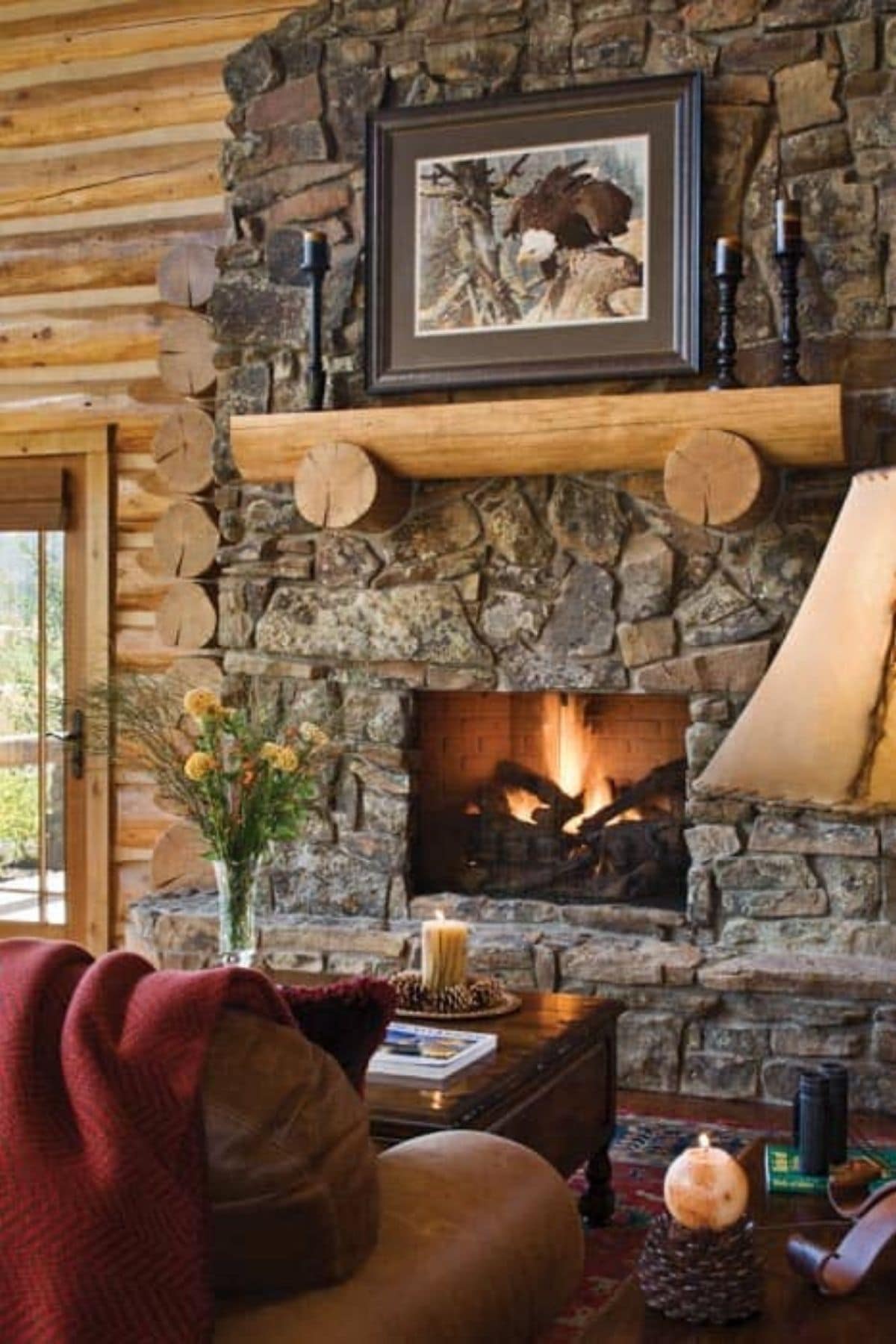 stone fireplace with wood mantle holding picture