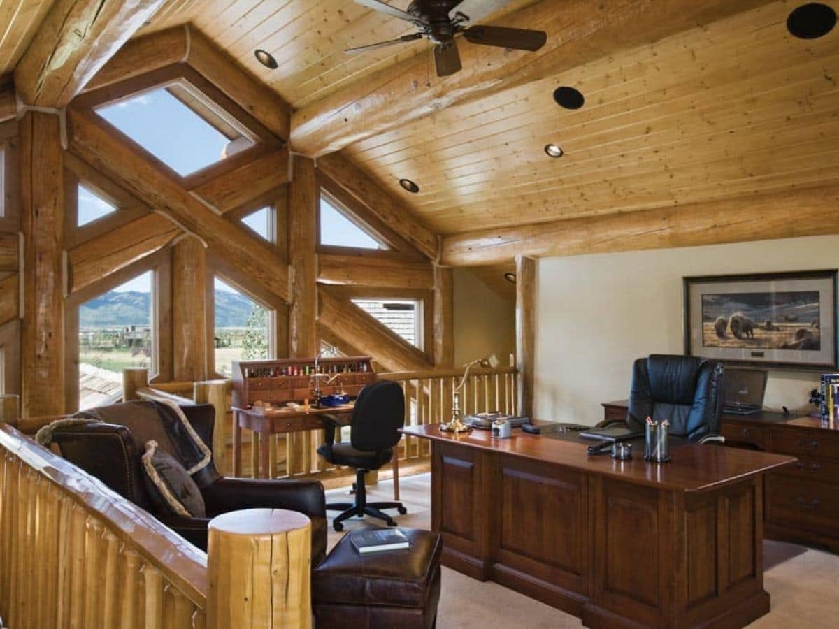 loft space with home office desk and chairs by picture window