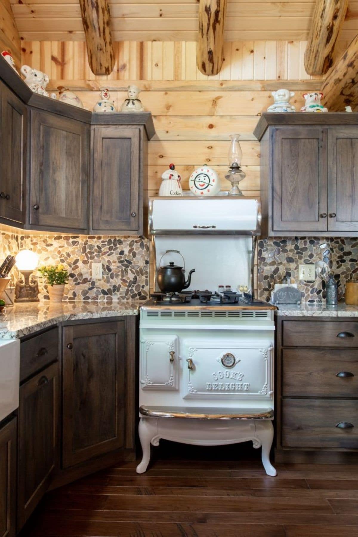 vintage white stove between dark wood cabinets
