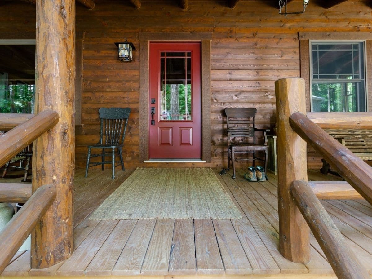 red door on front porch of log cabin