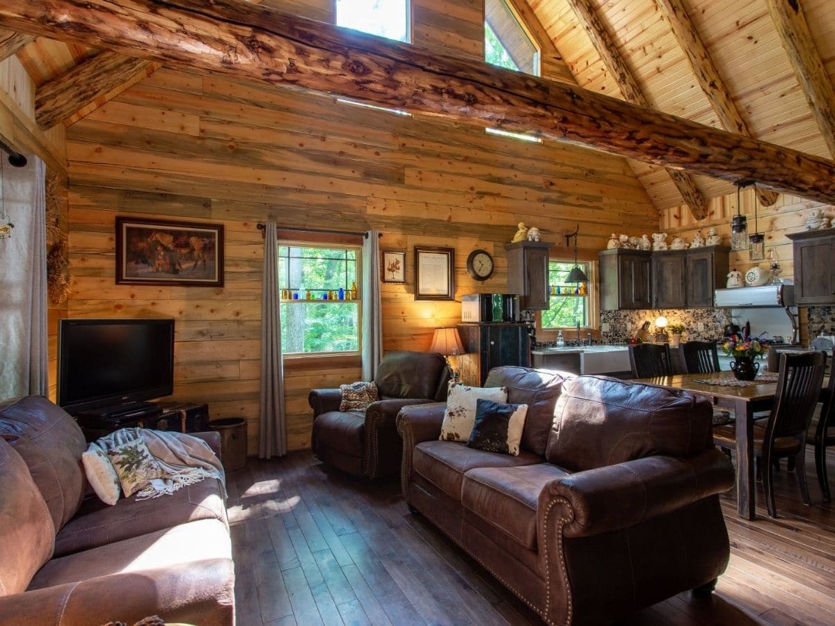 brown sofa in living room of log home