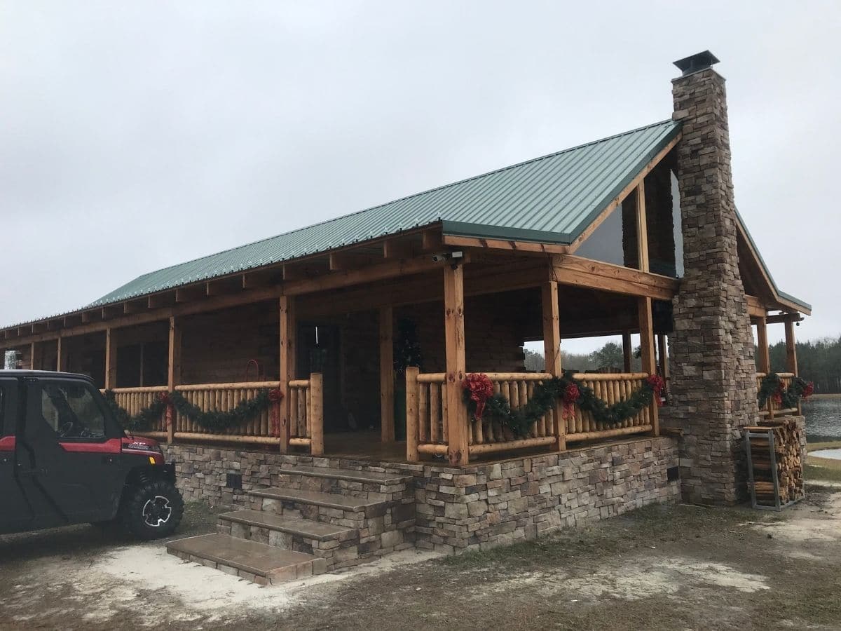 end of log cabin with stone chimney