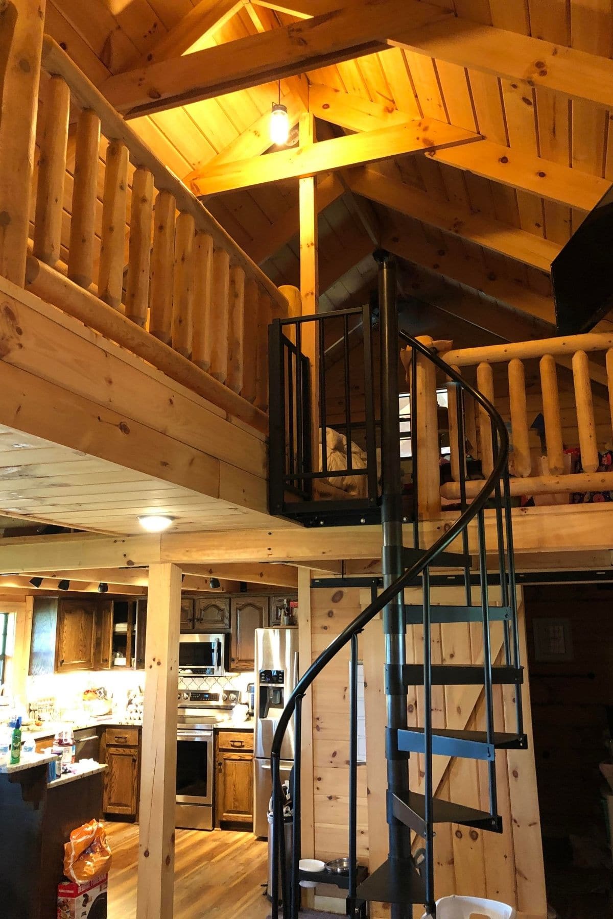 kitchen behind spiral staircase inside home