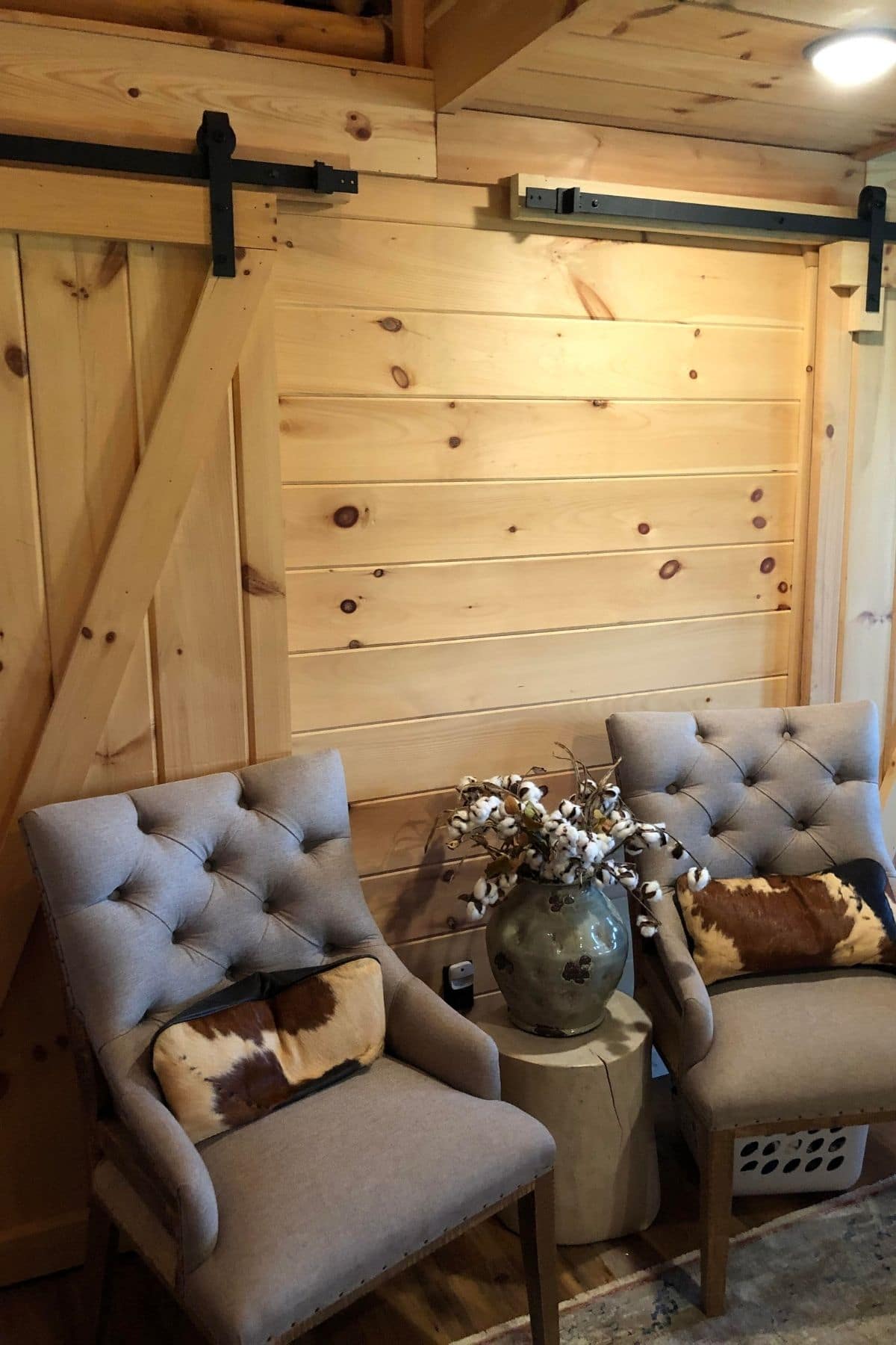 two gray chairs by light barn doors