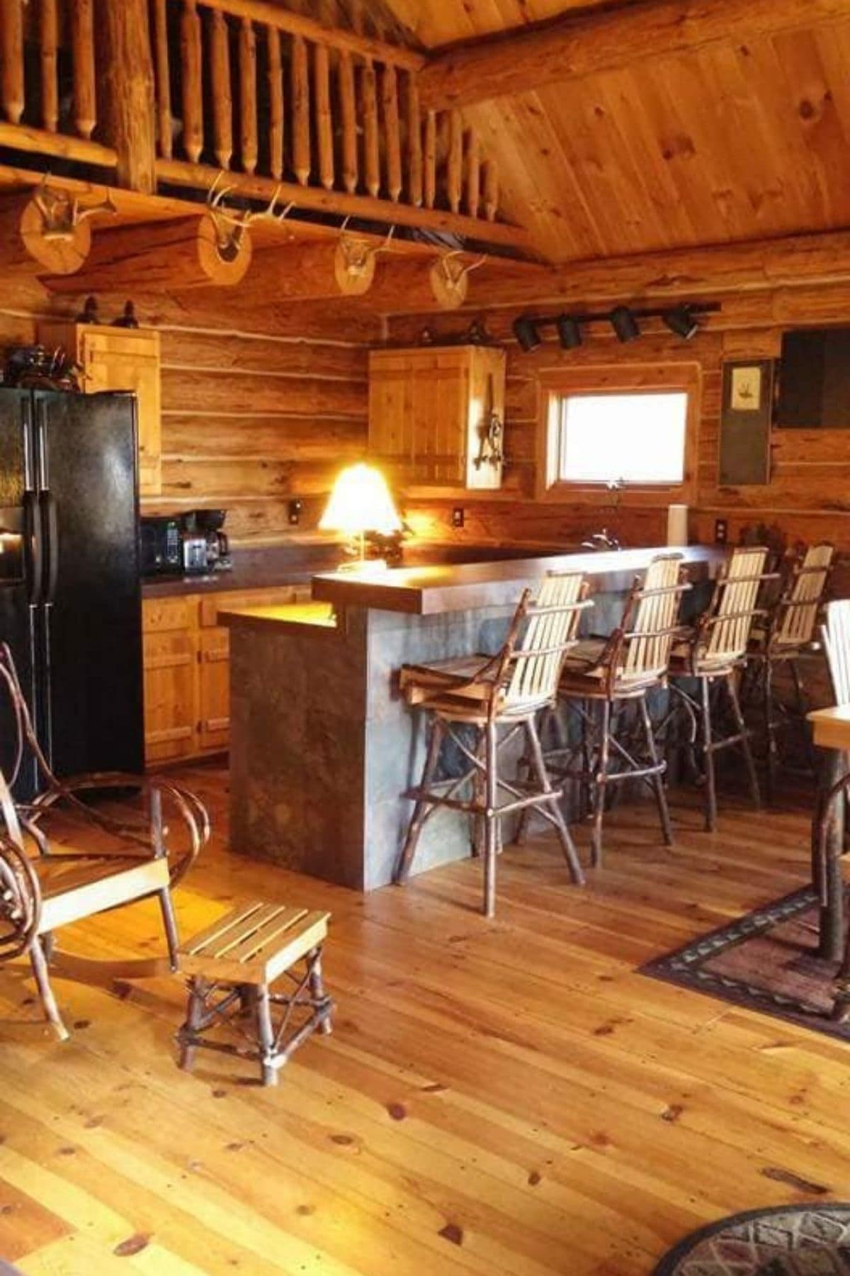 view into kitchen with chairs at bar