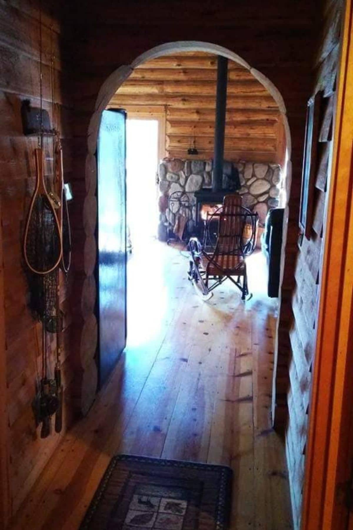 archway looking into living area with wood stove