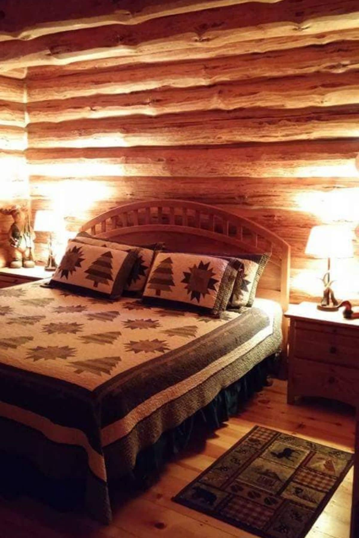 king size bed against log cabinw all