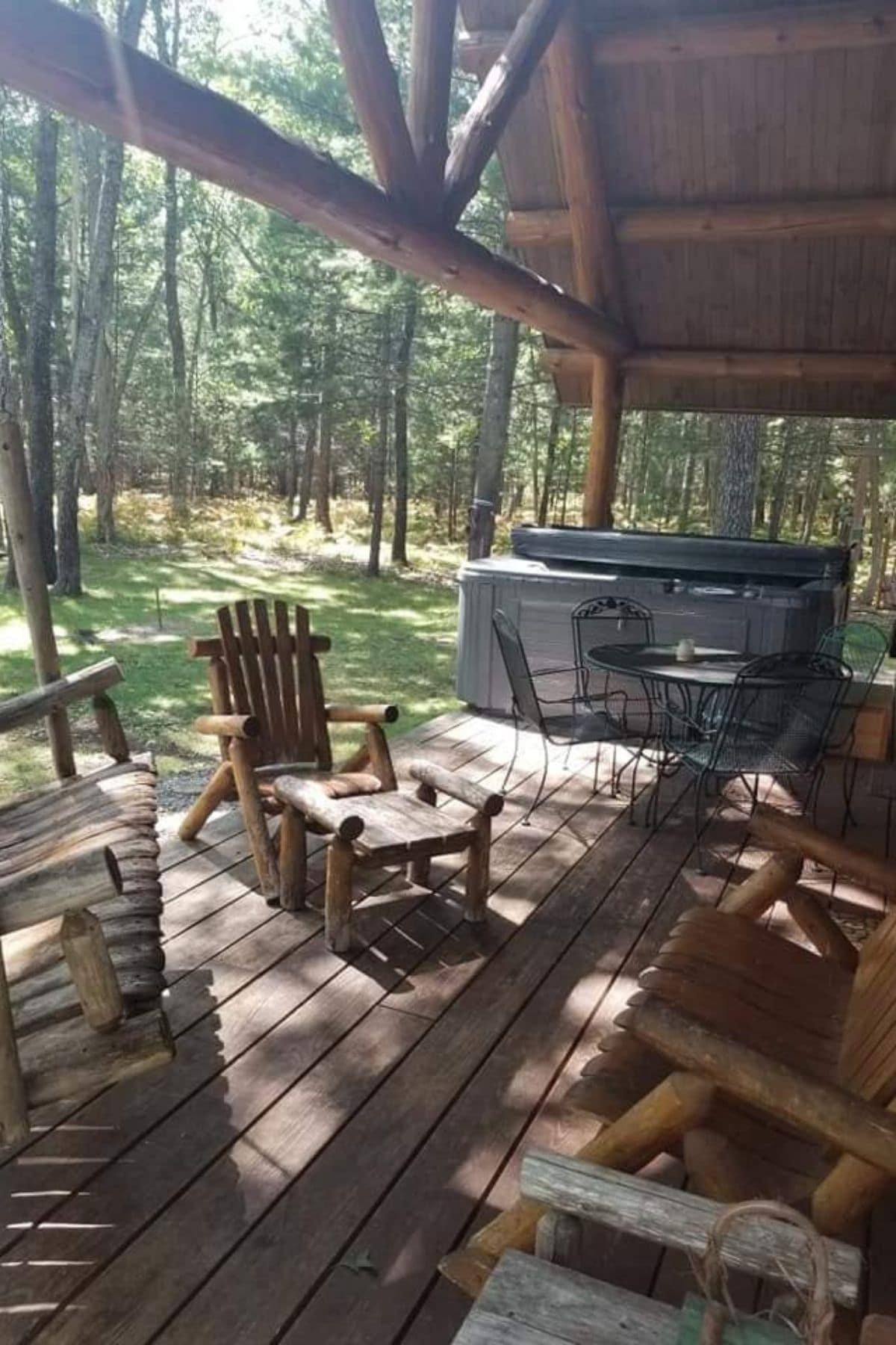 rocking chair next to hot tub on porch