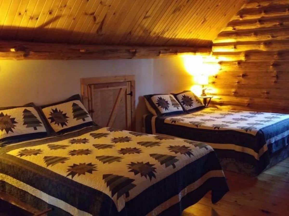 two beds against wall with wood door between