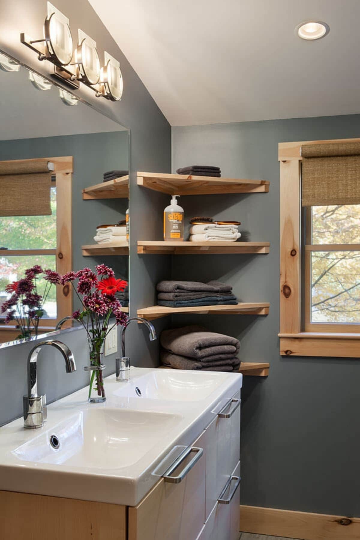 light blue walls with corner shelves and white vanity