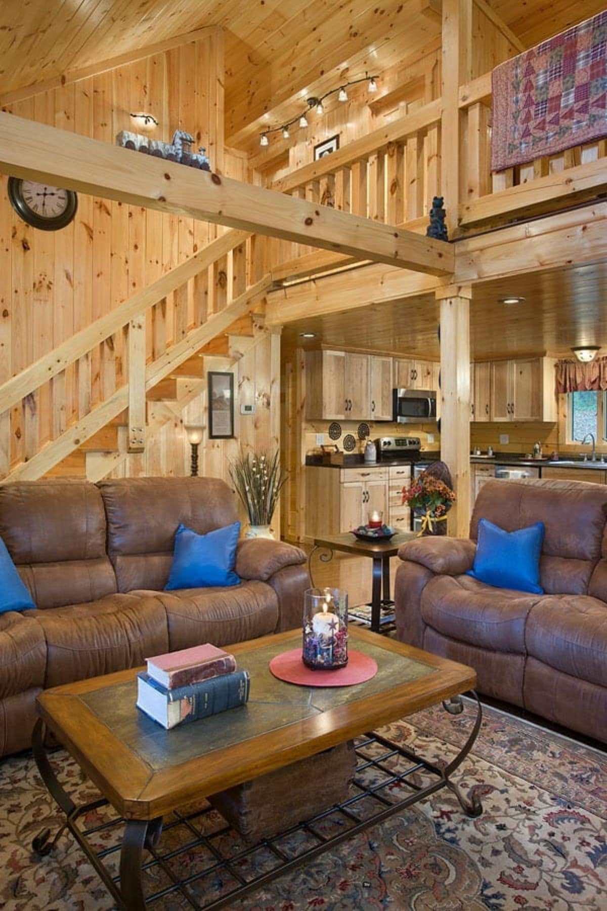 brown sofas with blue pillows and wood coffee table