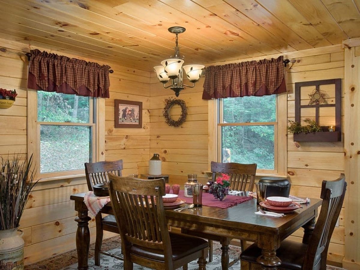 dark wood dining table with windows on both sides