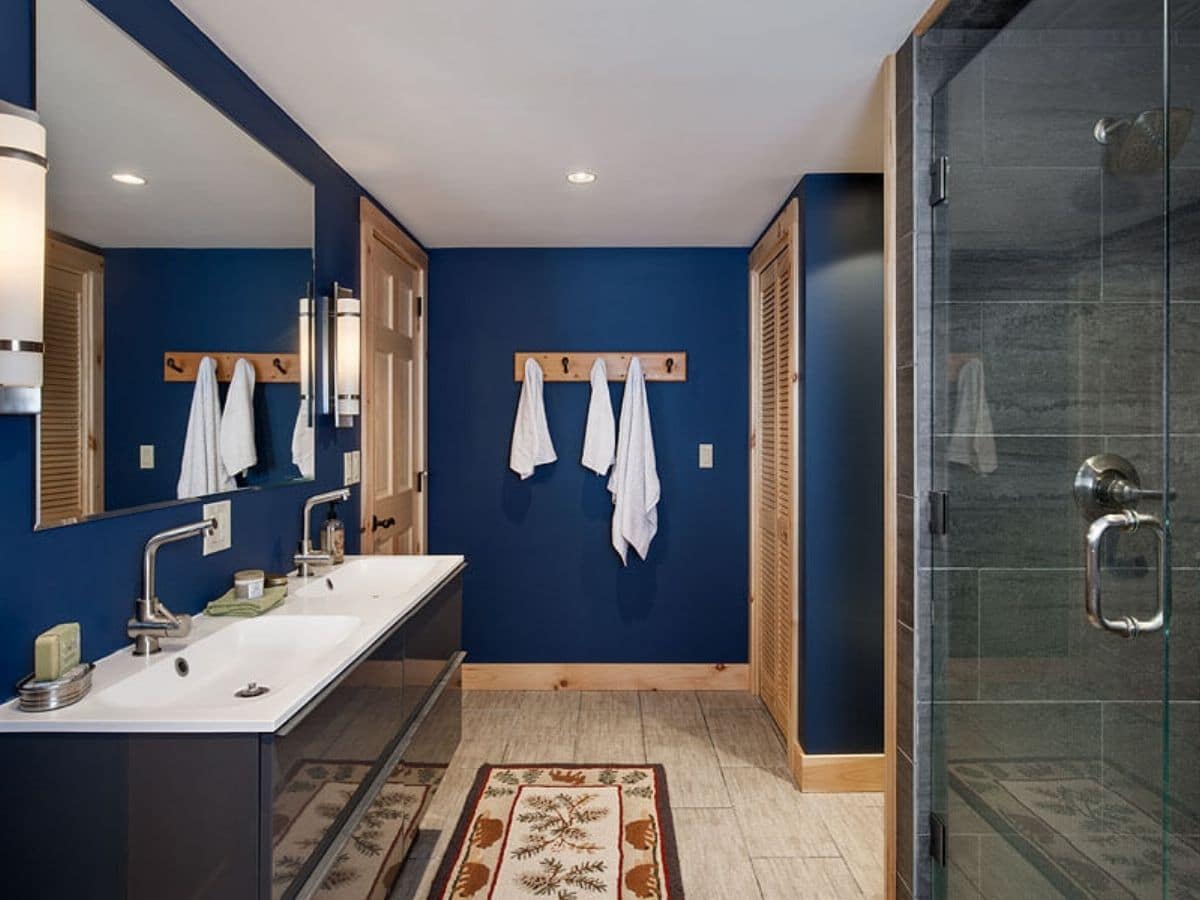 bathroom with dark blue wall and long white vanity