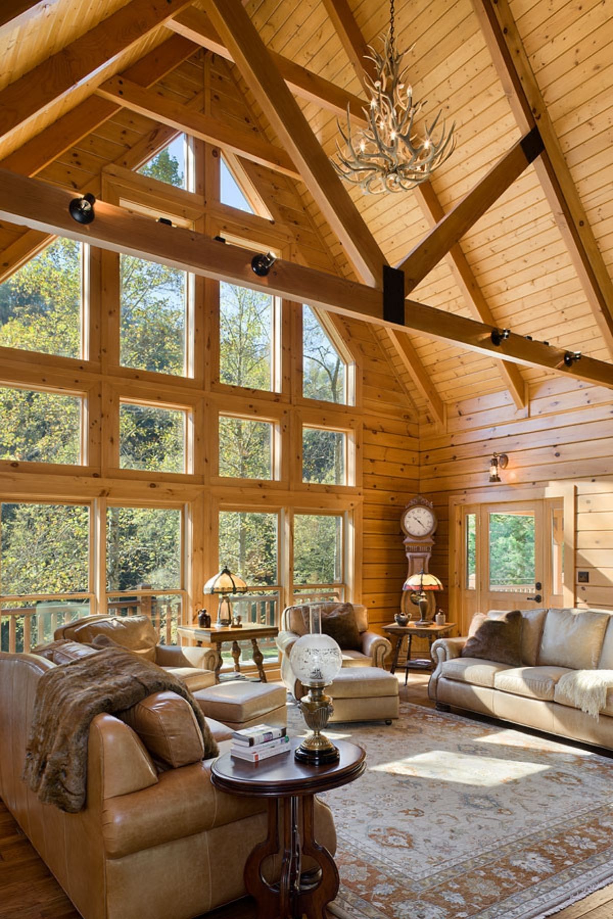 great room with wall of windows inside log cabin