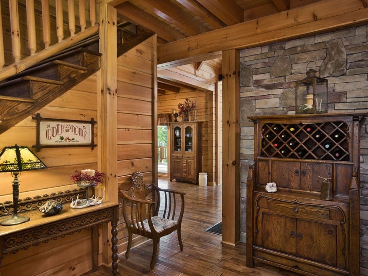 storage against stone wall with stairs to loft on left