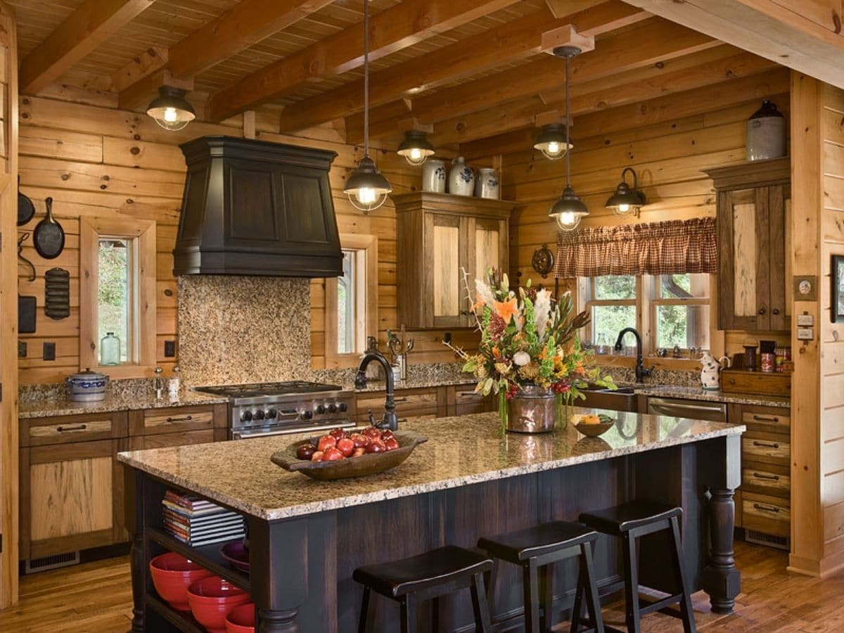 log home kitchen with modern look and island bar in middle