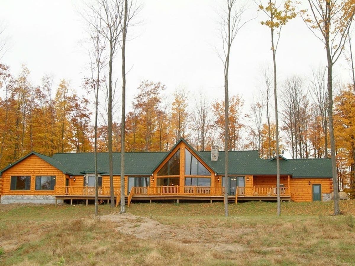 ranch style log home with green roof