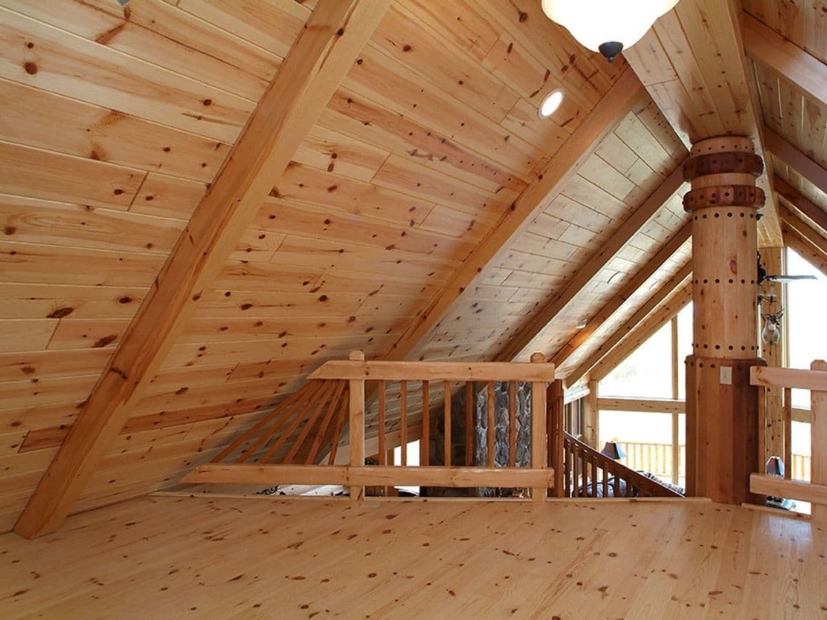 light pine paneling in loft with view over great room