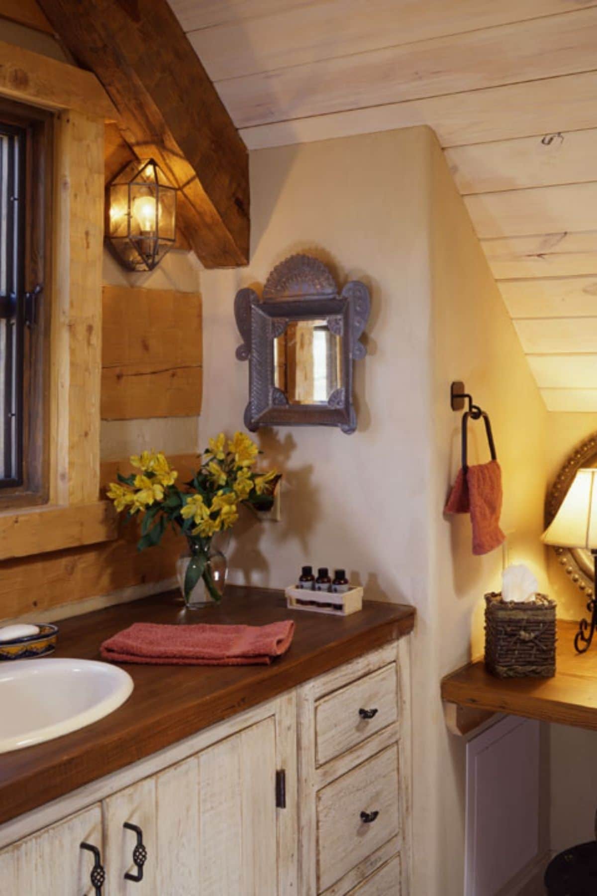 bathroom with vanity in light wood and dark wood countertop