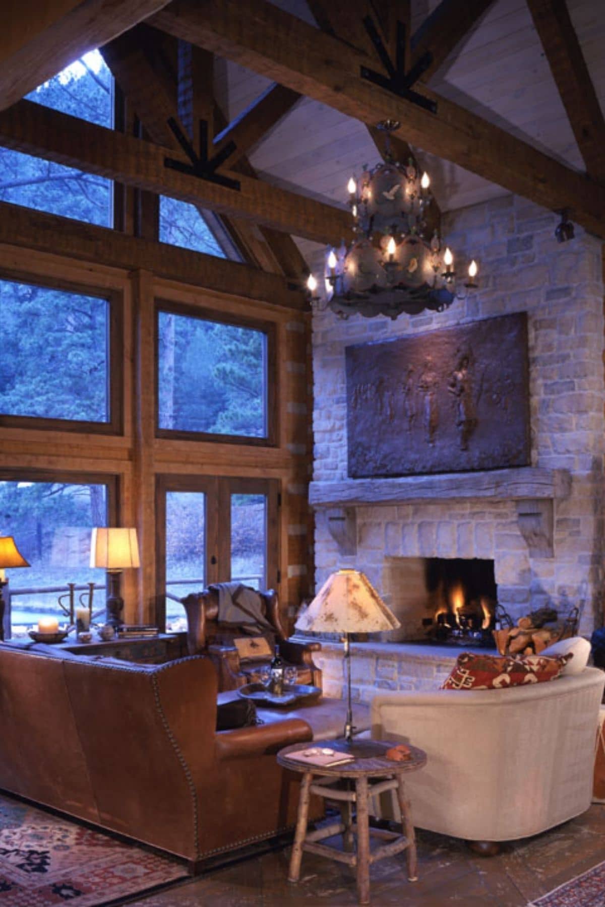 sofas by great room windows inside log cabin