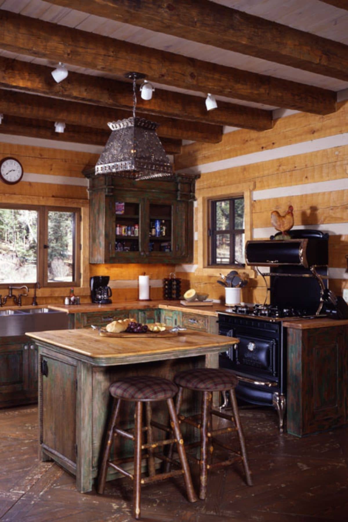 kitchen with vintage black stove and wooden island with stools