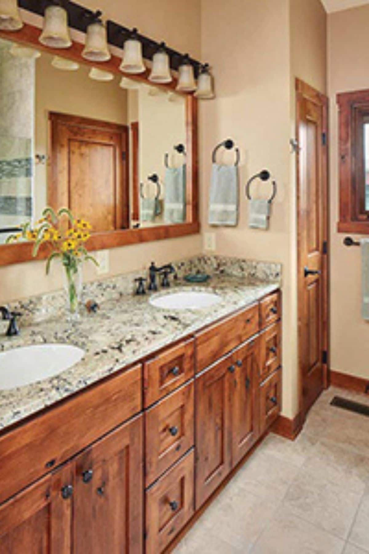 double vanity in bathroom with hollywood mirror lighting above