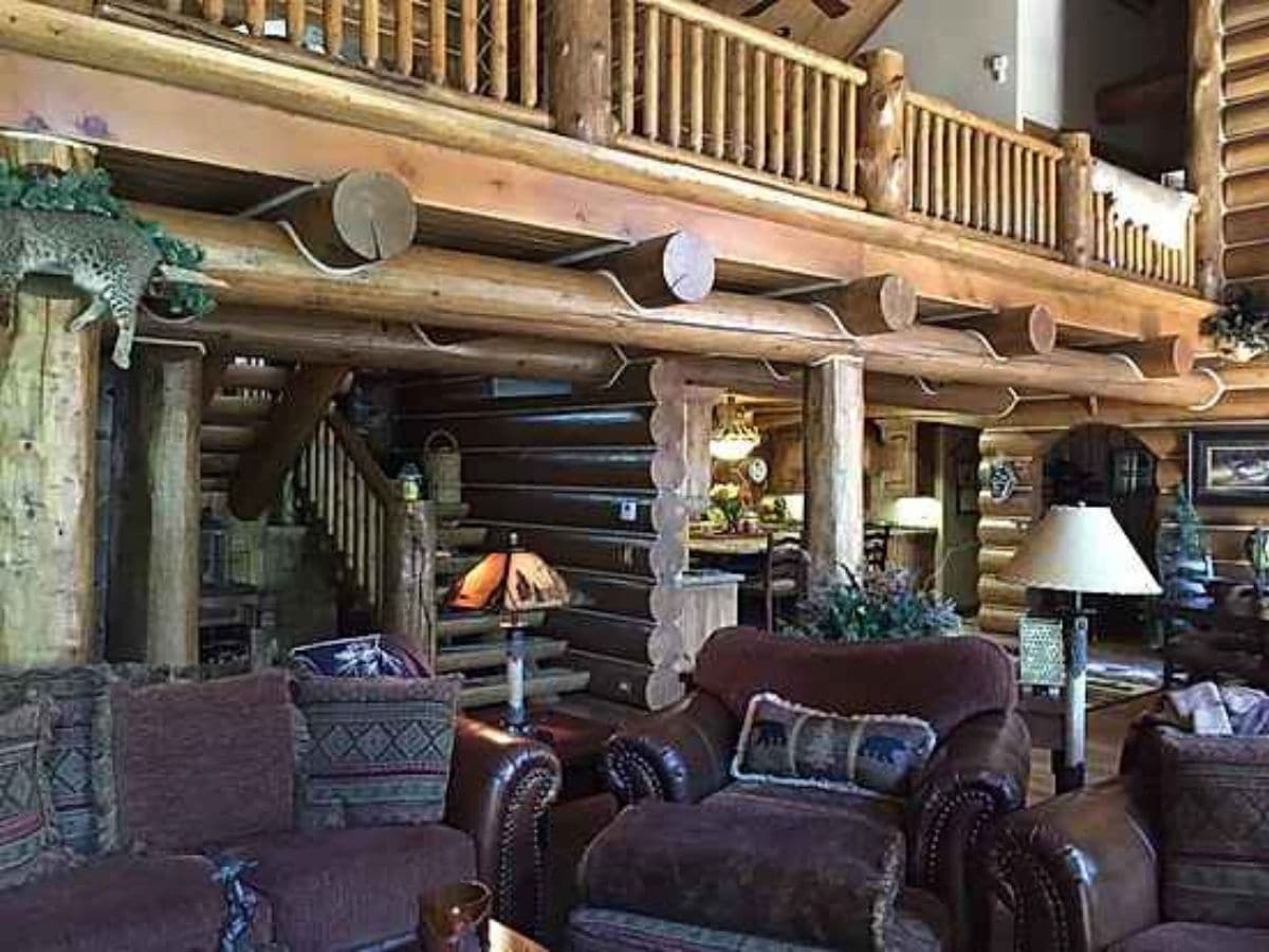 maroon chairs underneath log loft railing