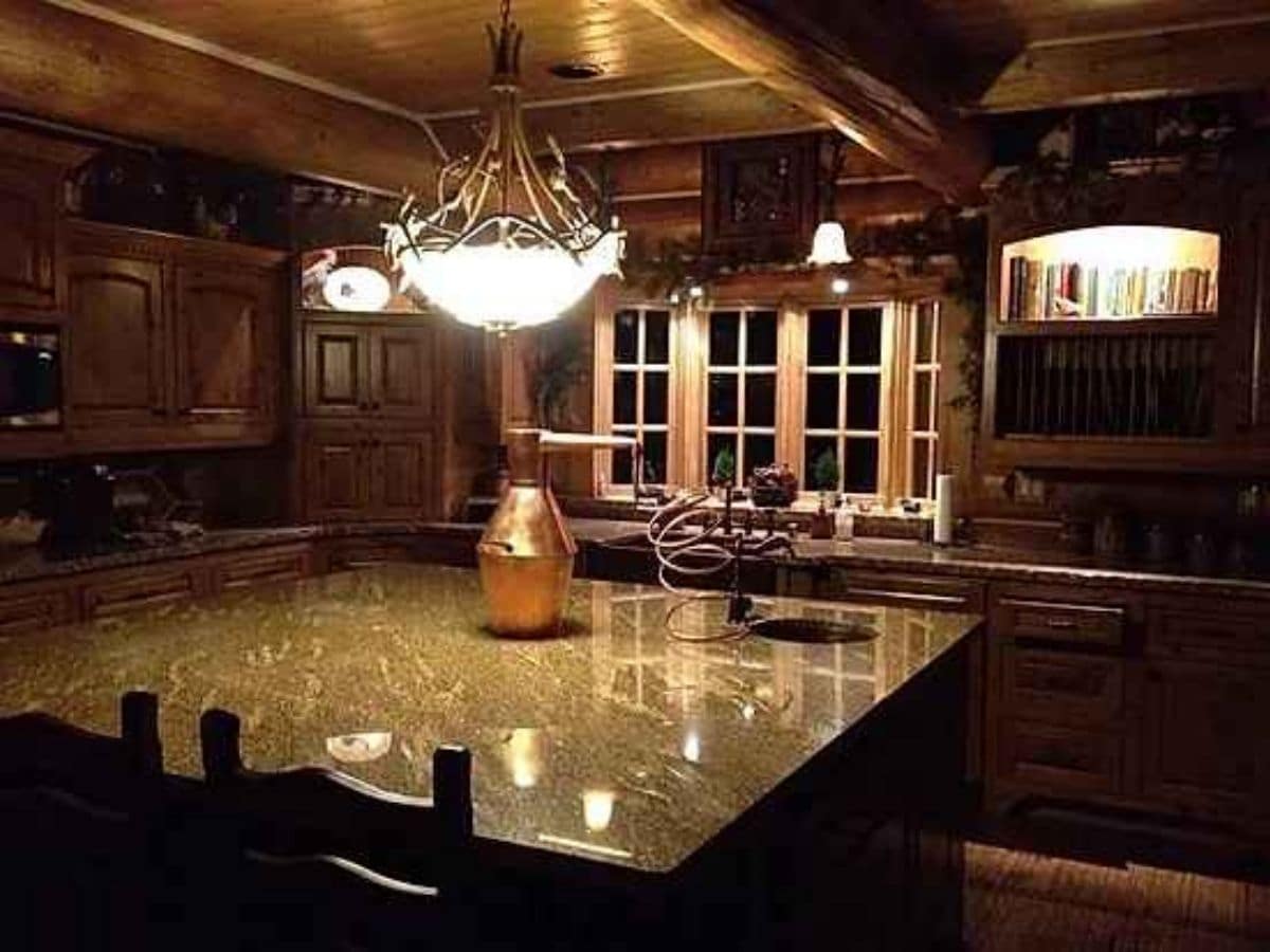 island in kitchen with antler chandelier above