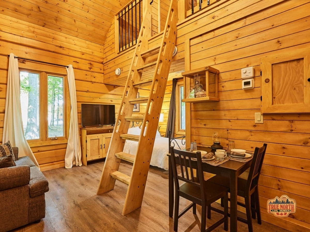 two person dining table against wall in log cabin