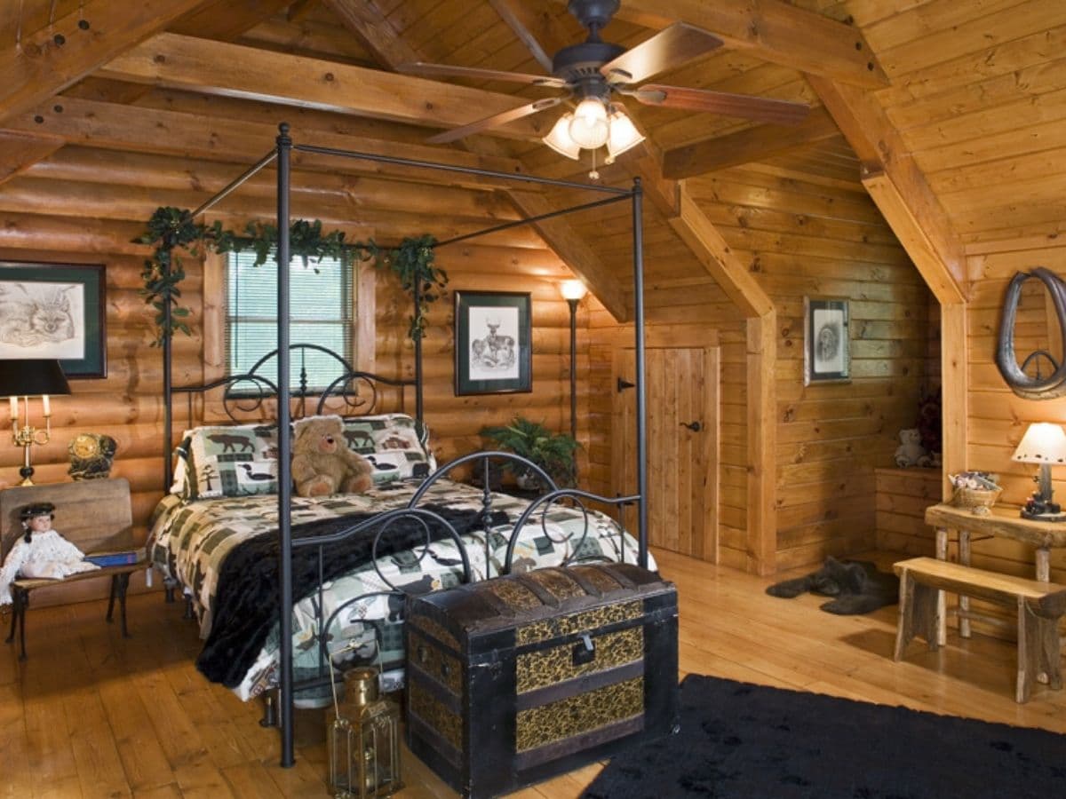 wire bed frame in loft bedroom with trunk at end of bed