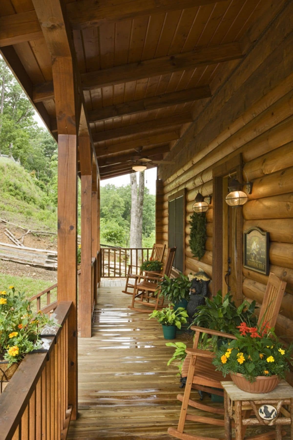 covered front porch with potted plants and rocking chairs