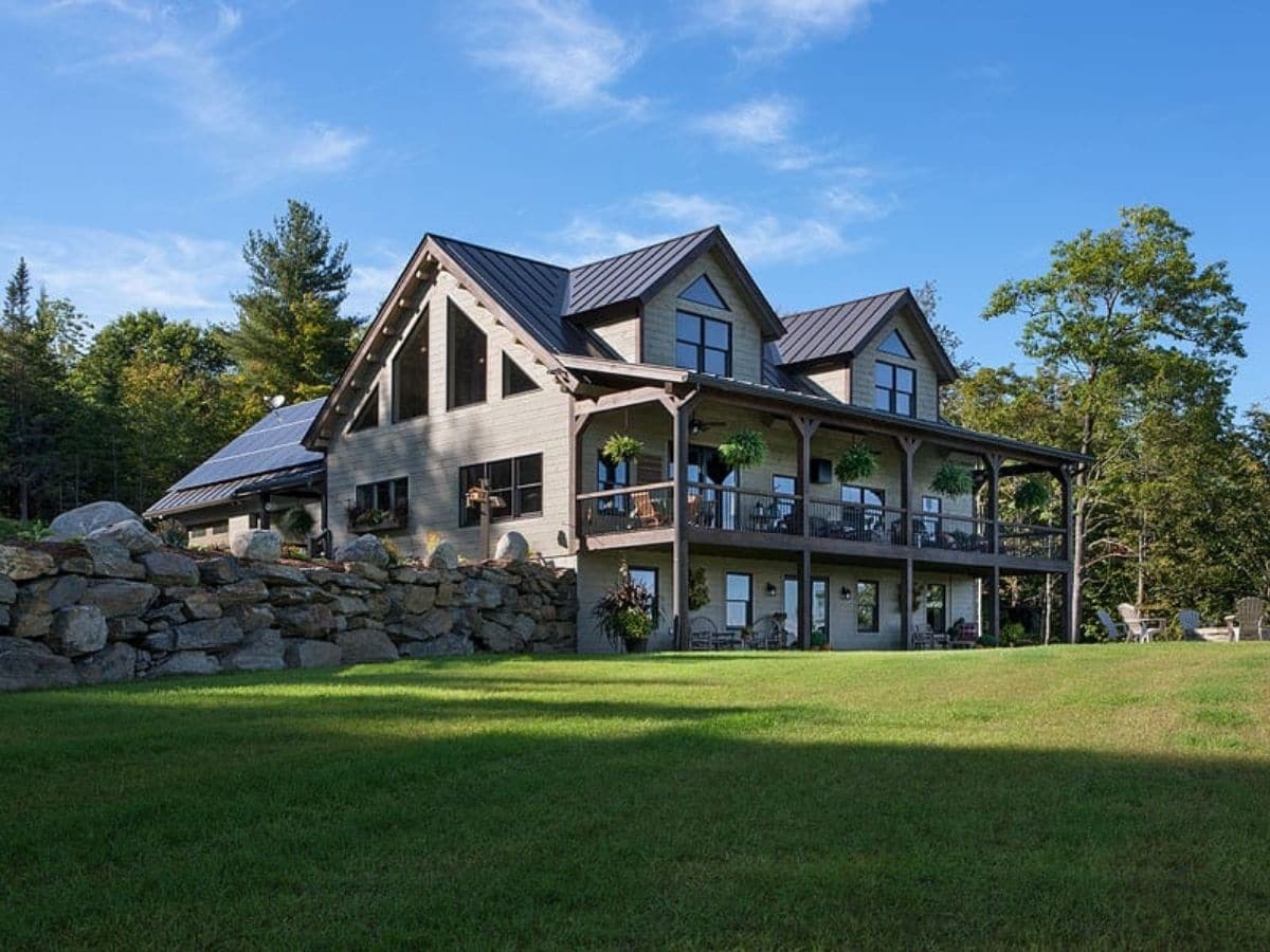 three story log cabin with gray wood exterior