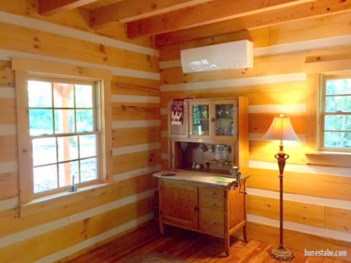 wooden buffet hutch against log cabin wall