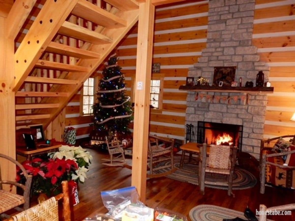 stone fireplace with christmas tree net to it