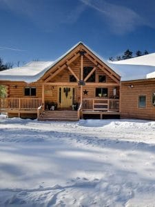 light wood log chttps://www.weightwatchers.com/us/m/cms/blog/fitness/syncing-ww-samsung-apple-fitness-trackersabin with porch in snowy setting