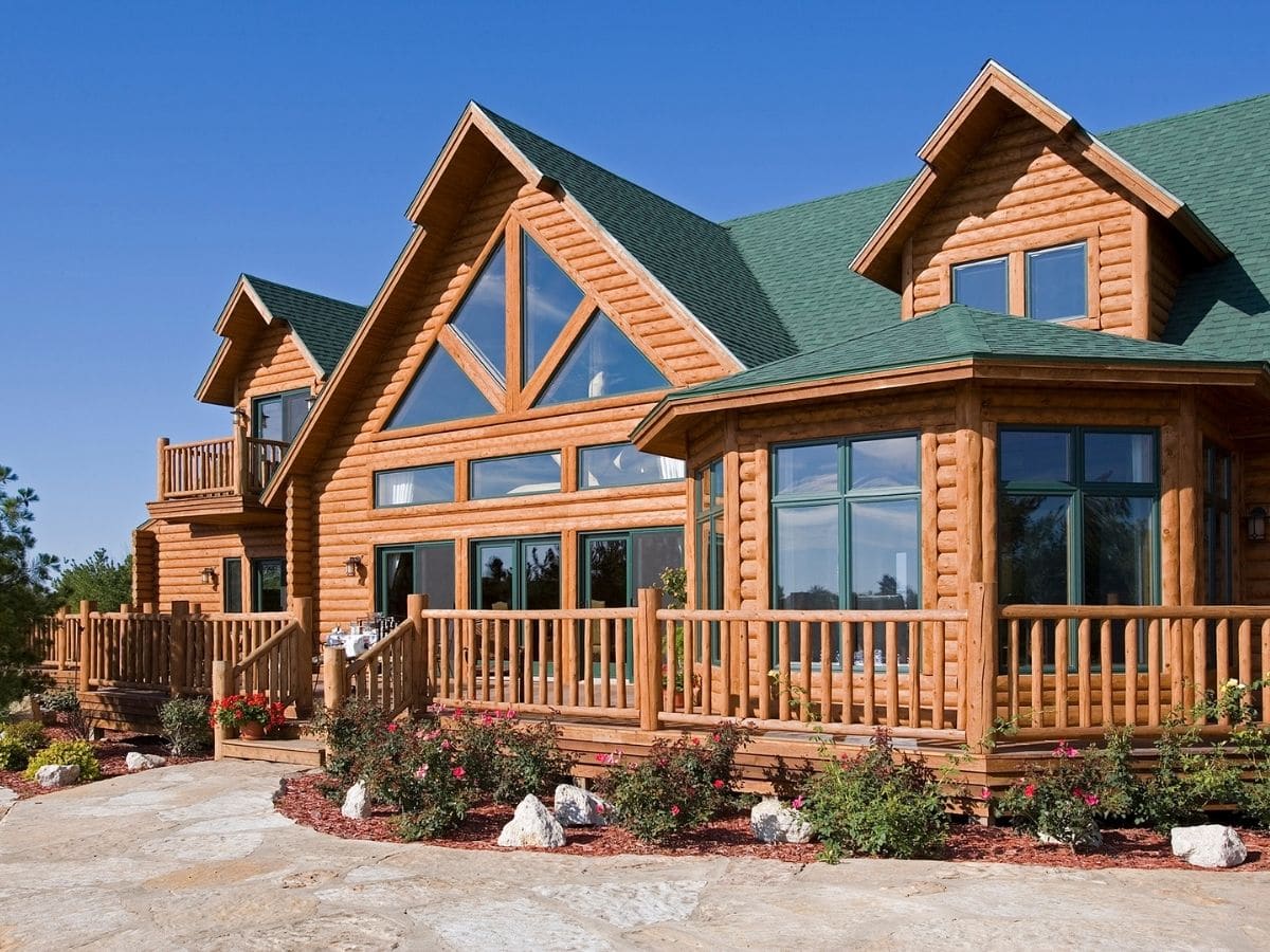 log cabin with great room windows and green roof