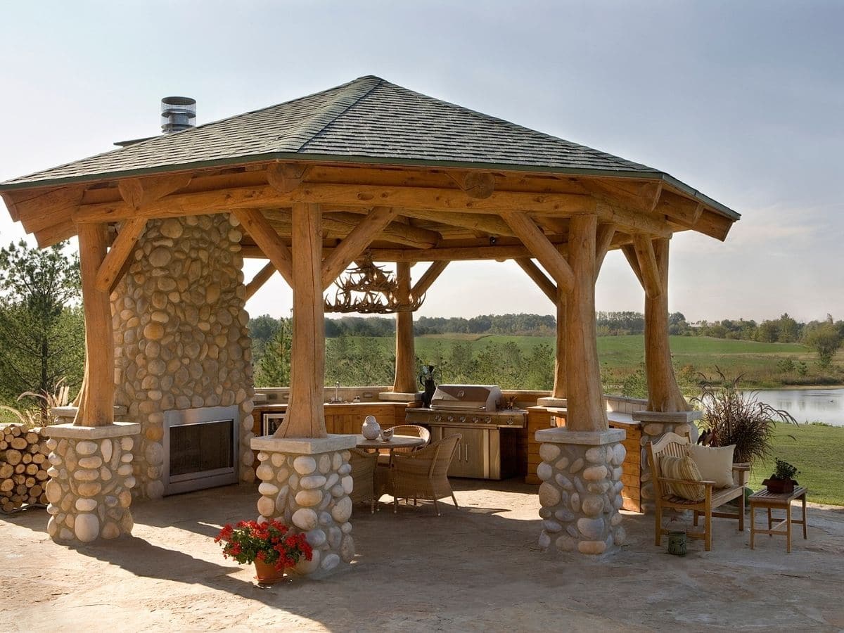 gazebo with stone and log columns with outdoor fireplace