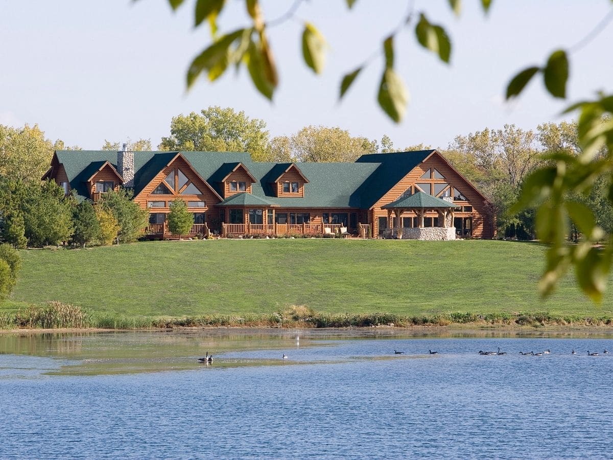 log cabin across from lake