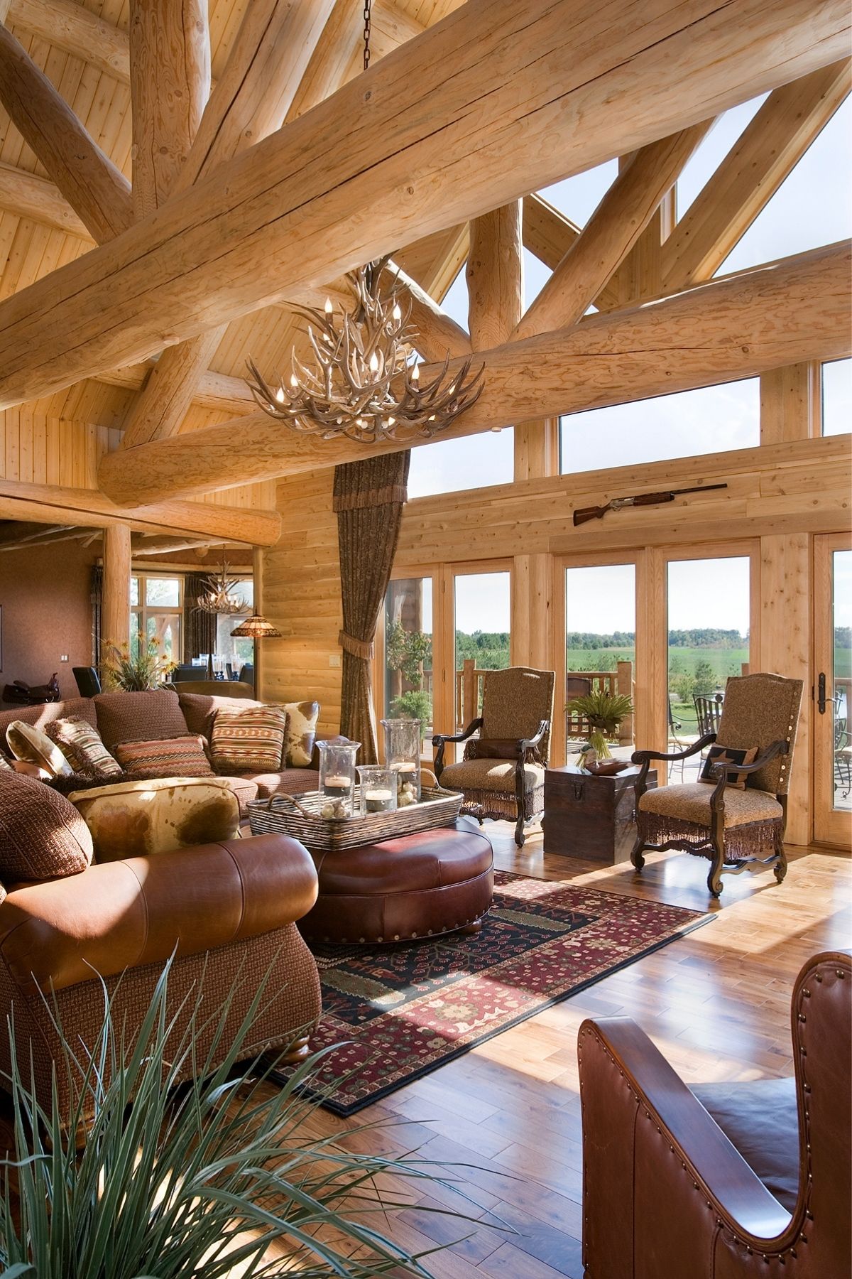 great room with brown leather sofas and picture window on wall