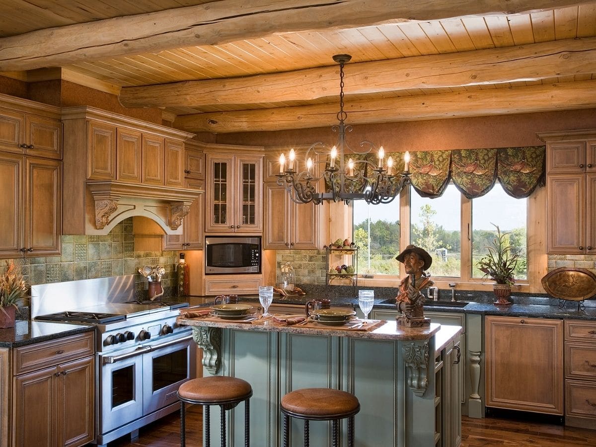 light teal island in middle of kitchen with wood stools and chandelier above island
