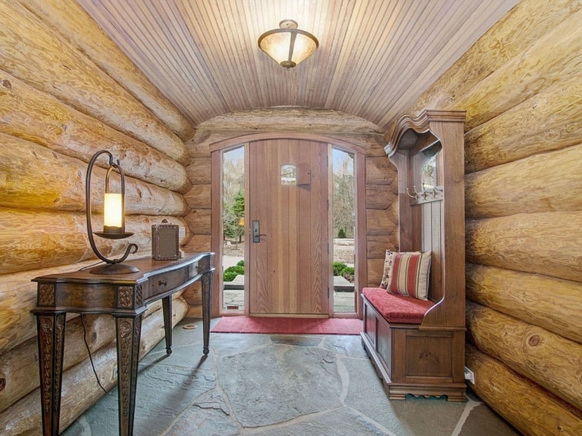 inside entry of log cabin with half log walls