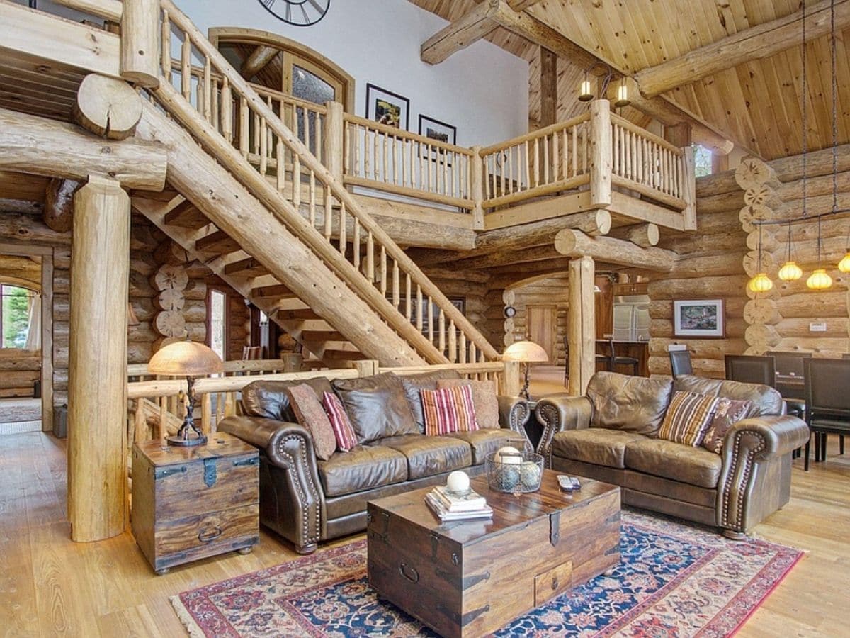 brown sofas with wood coffee table below loft landing with stairs in background