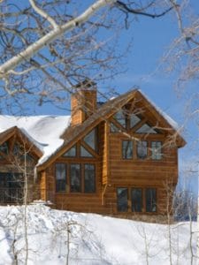 Log cabin against snow background