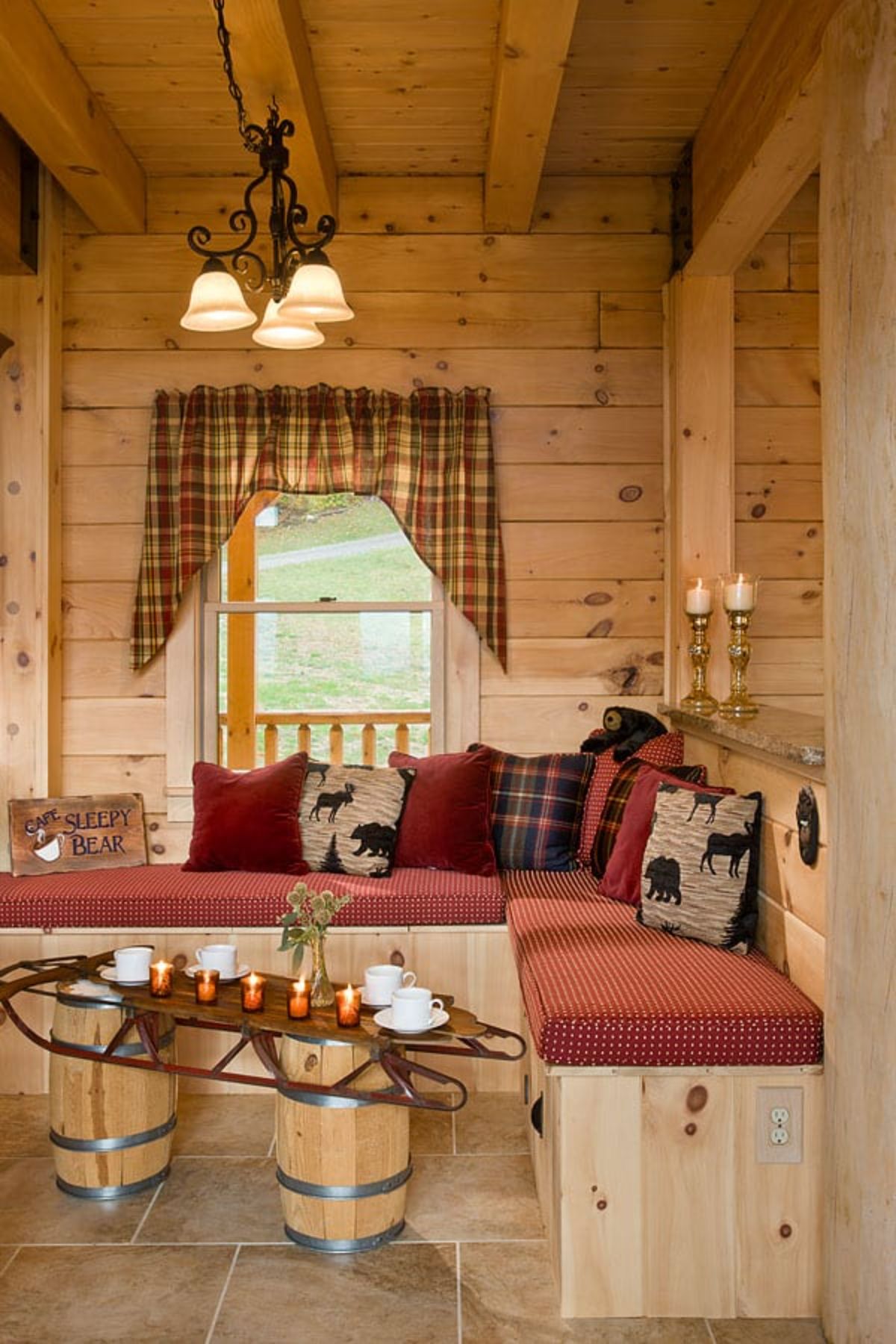 bench seat against wall with maroon cushions and unique wood table in front