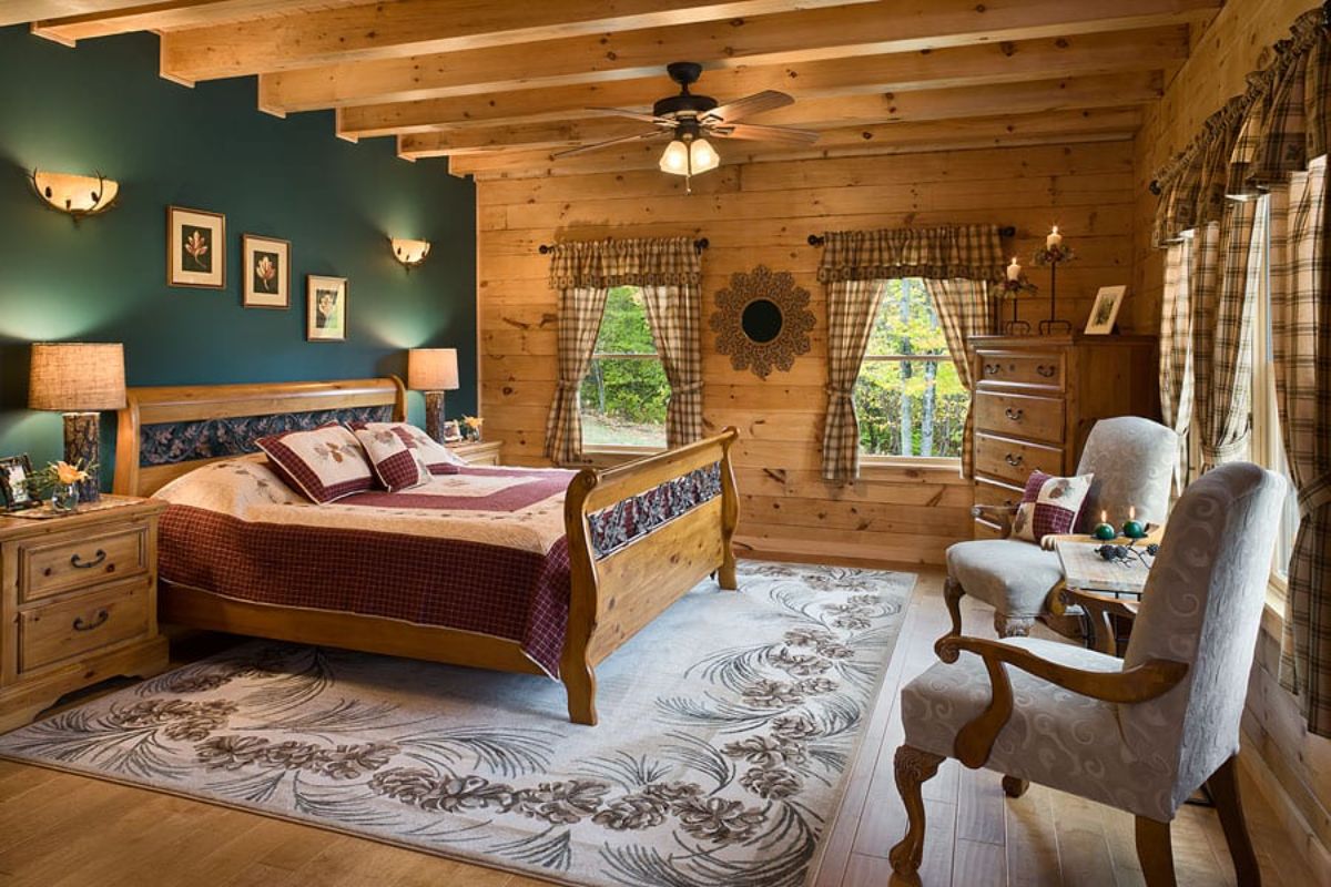 bed against green wall with log cabin walls on other sides